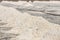 Close up piles of raw white sea salt in the salt farm