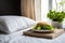 close up of a pillow and a plate of salad on a bedside table