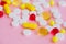 Close up of pills. Dietary supplements. Variety pills. Vitamin capsules on pink background