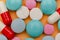 Close up of pills on orange background, concept of painkillers addiction. Lot of tablets, overdose