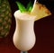 Close up of pina colada drink over pineapple created using generative ai technology