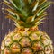 Close-up of pineapple on gray stripes background, square shot