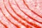 Close up of pink appetizing salami sausage pieces