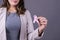 Close-up of a pink badge ribbon holded by a woman to support breast cancer cause