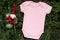 Close up pink blank template bodysuit with copyspace and Christmas decor