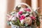 Close up of pink flower arrangement. Rose, Dianthus, Alstroemeria, Chrysanthemum. Bouquet of spring flowers in basket
