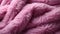 A close up of a pink fluffy blanket texture