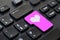 Close up of a pink heart return key on a computer keyboard