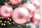 close up of a pink matte ball ornaments, hanging on christmas tree branches, Generative AI
