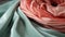 a close up of a pink and mint green scarf with a knot on it\\\'s end and a knot on the end of the end of the scarf