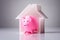 Close-up Of Pink Piggybank And House Model