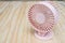 Close up pink portable USB fan on wooden frame for cool temperature