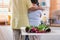 Close up pink rose with Asian Senior husband embrace wife while flower grrangement on table at kitchen at home in Valentine`s Day