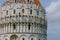 Close-up of the Pisa Baptistry under sky and clouds, in the Cathedral Square of Pisa, Italy