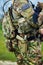 Close-up of a pistol in a holster and a submachine gun in the hands of a soldier