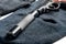 close up pistol silencer on black balaclava concept