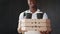 Close up pizza box. Young african delivery man in white uniform with pizza boxes, lunch box and coffee, looking at