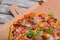 Close-up of a pizza in a carton box. Traditional italian pizza on a gray background. Nutritious foods. Pizza delivery.