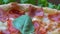 Close up. Pizza with tomatoes and cheese background rotating on the kitchen table