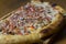 close up of a pizza with well browned edges and plenty of toppings