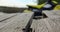 Close up of planks of a wooden pier. Jetski in the background.