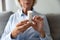 Close up plastic bottle with pills in female wrinkled hands