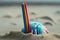 close-up of plastic straw washed up on beach, drawing attention to the environmental damage caused by single-use