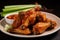 Close-up of a plate of crispy chicken teriyaki wings, hot and fresh out of the oven, served with a side of dipping sauce