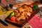 Close-up of a plate of food featuring a succulent roasted chicken