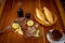 Close-up of a plate of freshly cooked meat accompanied by limes, bread and sauces on a wooden table