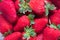 Close-up of a plate full of ripe strawberries