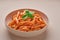 Close-up of a plate with Penne All`arrabbiata pasta cooked according to a traditional Italian recipe on a light background