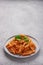 Close-up of a plate with Penne All`arrabbiata pasta with copy space vertical frame