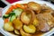 Close up of plate with slow cooked beef with potatoes carots and vegetables in sauce
