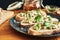 Close up on a plate of toasts with roquefort cheese, walnuts, honey and basil. Selective focus