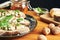 Close up on a plate of toasts with roquefort cheese, walnuts, honey and basil. Some cheese, nuts and honey in the background