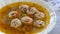 Close up plate with traditional romanian meatballs soup ciorba de perisoare