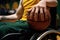 close-up of a players hand on the wheel of a sports wheelchair