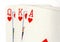 Close up of playing cards showing a run of queen, king and ace.