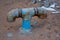 Close up of plumbing fixture in the dirt outside for home improvement and DIY concepts