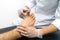 Close-up of a podiatrist performing an examination of a patient on a stretcher.