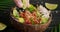 Close up poke bowl video, person preparing and serving poke dish with salmon cubes, edamame beans, cucumbers, video 4k