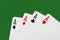 Close up on a poker of aces isolated on green table with  copy space for your text