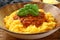 Close up Polenta with ragu` bologenese in ceramic bowl