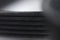 Close-up of a poly V-belt of a generator on a gray background in shallow depth of field. Background for rubber products