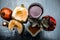 Close up of pomegranate face pack with papaya,grape seed oil and extract or juice on wooden surface in white colored bowl raw pome