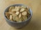 Close up poppy seed sesame crunchy crackers in gray bowl on wood