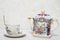 Close up porcelain English teapot and cup of tea