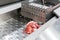 Close up pork or meat sliced on metal rail transport food of automatic and precision slicer machine for industrial food