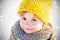 Close up porrtrait of beautiful child on snowy background. Cold and travel winter tourism active holidays in December
